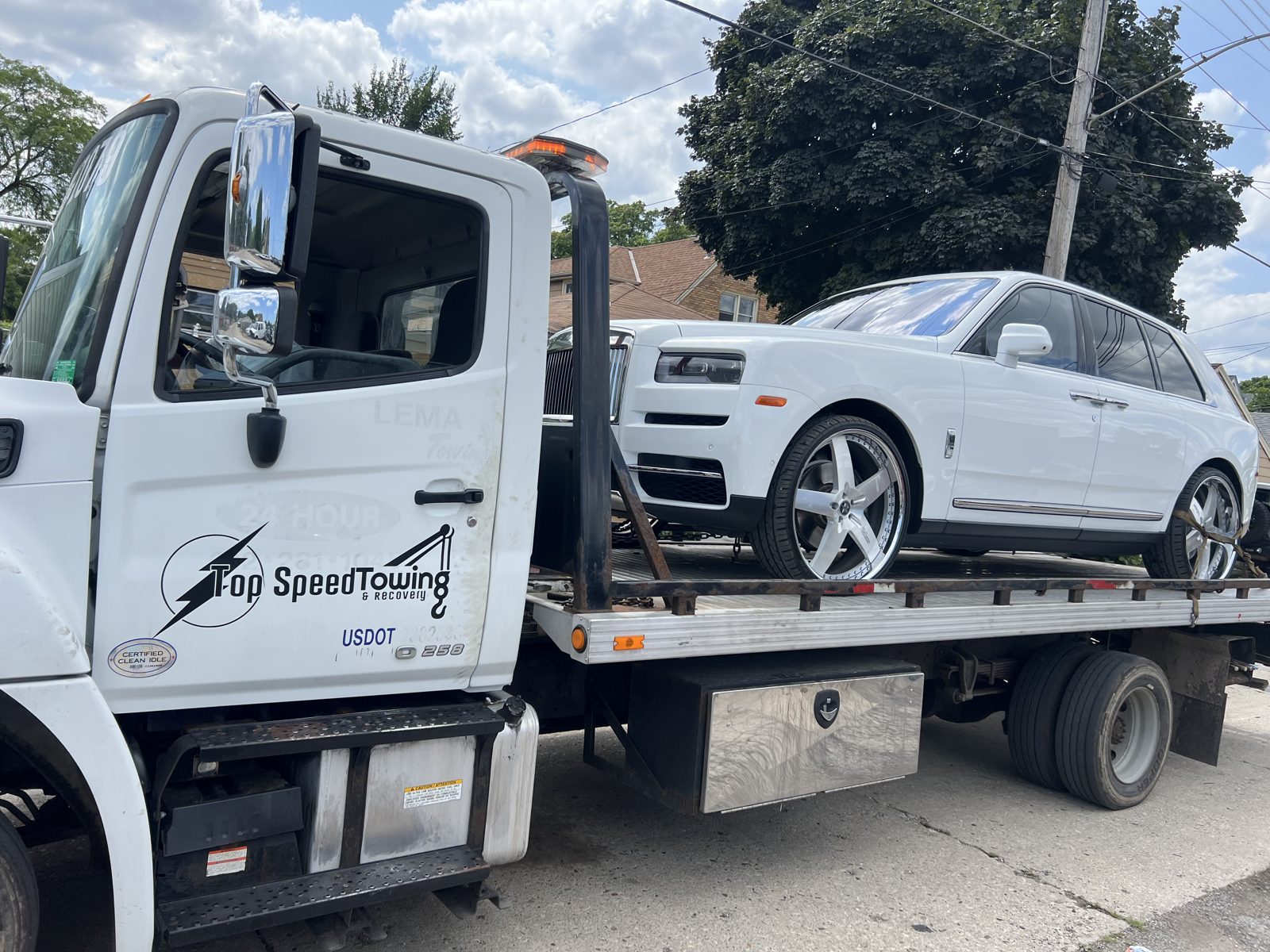 Top Speed Towing flatbed truck transporting a vehicle in Milwaukee